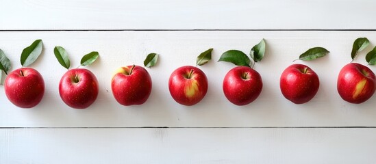 Aufkleber - Apples arranged in a row on a white wooden table background. with copy space image. Place for adding text or design