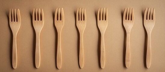 Aufkleber - Wooden forks on a cardboard backdrop Eco friendly disposable tableware Top view Copy blank space for text