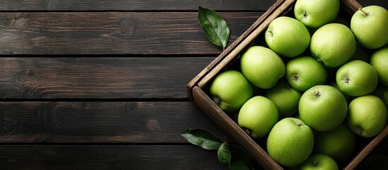 Wall Mural - Ripe green apples in a wooden box Top view with copyspace