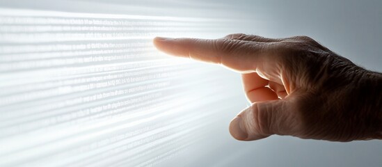 Hand pointing at glowing digital code stream.