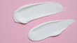 © Tark - Pieces of cosmetic cream on pink background. Generative AI