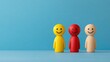 © The 2R Artificiality - Customer Satisfaction Survey Concept Featuring Colorful Smiley Figurines in Yellow Red and Beige Against Blue Background Representing User Feedback and Service Quality Evaluation
