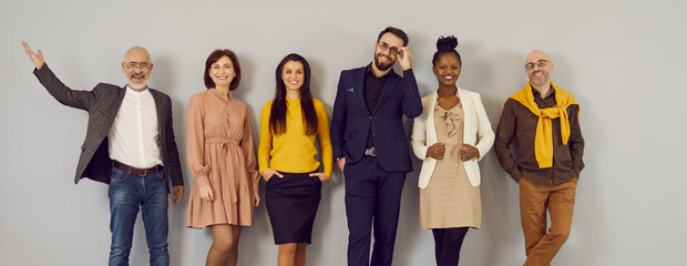 happy people in clothes suitable for office dress code standing in studio. mixed race multiethnic gr