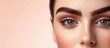 © The 2R Artificiality - Elegant Close-Up of Woman's Eyes with Bold Eyebrows in Beauty Salon Soft Pink Background Aesthetic Beauty Procedure Focus on Eyebrow Tattooing