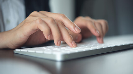 Wall Mural - Closeup, business woman hand typing on desktop computer keyboard, online working, searching the information, surfing the internet on office table, remote work, online job, business background