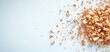 © Suhainee - A close-up of wood shavings scattered on a light surface, showcasing the texture and color of the wood.