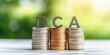 © Pixelbiz - DCA wooden block concept. The image features stacked coins with the letters 'DCA' prominently displayed, symbolizing Dollar Cost Averaging in finance and investing.