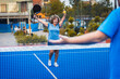 © Zoran Zeremski - Female adult padel player celebrates victory in padel on outdoor court.