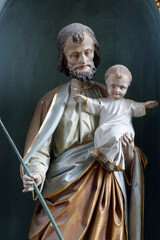 Wall Mural - Saint Joseph holding baby Jesus statue at the altar in the Parish Church of Saint Joseph in Sisljavic, Croatia