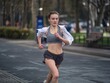 © skotobaza - young athletic woman running down the street