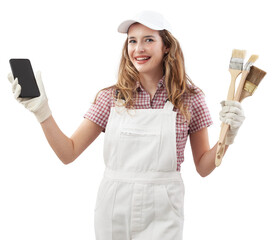 Wall Mural - Happy woman in painters overalls showing phone for online shopping of colors and products to painting home walls and renovate the house, holding paint brushes and browsing an online paint store