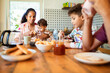 © Marko Geber - Happy family eating breakfast together at kitchen table
