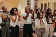 © Jacob Lund - Happy employees applauding in office