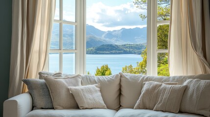 Poster - Cozy white sofa by a window offering a stunning mountain and lake view in a serene living space