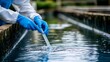© Pinit - An environmental engineer collects a water sample for analysis.