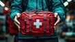 © Ethan Brooks - The red first aid kit represents preparedness for medical emergencies.