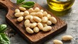© fivan - Cooked lima beans resting on a wooden cutting board, isolated with olive oil drizzled nearby
