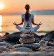 © SSTC AI Photo&Video - Sunset Serenity: A woman meditates on a tranquil beach at sunset, a carefully balanced stack of stones in the foreground symbolizing peace and balance.