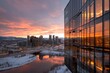 A rooftop view of a cityscape at sunset, with the warm light reflecting off glass buildings