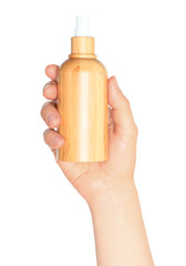 Wall Mural - Woman hand holds a wooden cosmetic bottle, on transparent background close-up, template for cosmetics ads