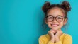 © AH TAR STOCK - A young girl with glasses is smiling and looking at the camera