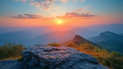 Wall Mural - majestic sunset over mountain range, viewed from rocky peak.