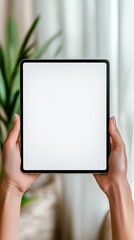 Wall Mural - female hands holding modern digital tablet with blank white screen providing mockup template for des