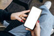 © KEA - Mockup woman's hand holding using smart phone with white blank screen POV at coffee shop, mobile app design and advertising, online marketing