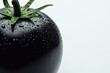 © Denis - Unique black tomato with dew droplets glistening in bright light showcasing its natural sheen and fresh appearance on a plain surface