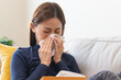 © Pormezz - asian woman blowing nose and have allergy
