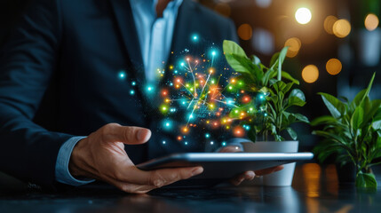 Poster - businessman holding tablet with colorful digital effects and plants in background, symbolizing innovation and technology in modern workspace