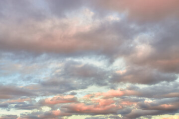 Wall Mural - a beautiful sky tinted by the sun leaving vibrant shades of gold, pink, blue and multicolored. cloud