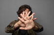© kues1 - covering face with hand and putting other hand up front to stop camera, refusing photos or pictures
