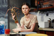 © SHOTPRIME STUDIO - Woman holding lobster in kitchen setting with copy space for seafood recipes and culinary concepts