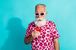 © deagreez - Portrait of funky aged man sip cocktail wear leopard print costume isolated on turquoise color background