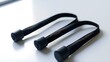 © Atthapon - Three black rubber bands are on a white surface