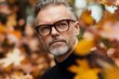 © Dina - handsome attractive man in glasses in his 50s in autumn park,  glasses optics horizontal  ads banner