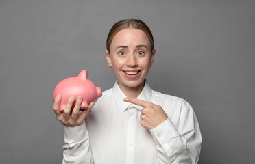 Poster - pretty blonde woman with a piggy bank