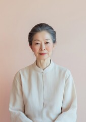 Aufkleber - Portrait of an East Asian Woman in Minimalist Outfit, Highlighting Her Calm Expression and Elegance in a Bright Portrait