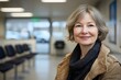 © Gerard - Older woman smiling in waiting room