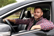 © New Africa - Happy man behind steering wheel of modern car, view from outside