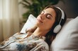 © Anton - Favorite Song: Relaxing young woman enjoying music at home with closed eyes and earphones