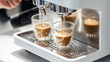 © Zahra - Brewing espresso in to glass cups silver coffee espresso machine white and clean interior. Barista working with coffee machine and making espresso coffee, speciality coffee black arabica
