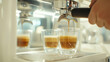 © Zahra - Brewing espresso in to glass cups silver coffee espresso machine white and clean interior. Barista working with coffee machine and making espresso coffee, speciality coffee black arabica