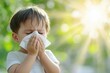 © Anna - A child sneezing into a tissue while standing outdoors in bright sunlight, surrounded by greenery, illustrating seasonal allergies and pollen sensitivity