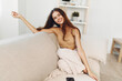 © SHOTPRIME STUDIO - Comfortable, Happy Woman Sitting on Soft White Wool Couch in Cosy Living Room
