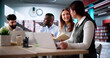© Andrey Popov - Students Learning Online At University Library