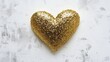 © atipong - A gold glitter Heart on a flat white plaster surface