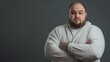 © Thavesak - Portrait of a Man with a Beard in a Cozy Robe Against a Gray Background