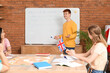© Pixel-Shot - Male teacher conducting lesson to young students at language school